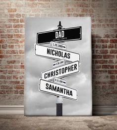 a street sign in front of a brick wall with the words dad and nicholas on it