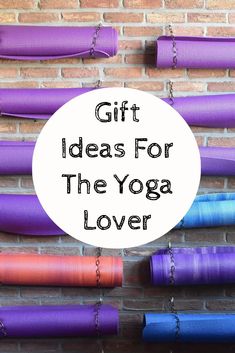 yoga mat with the words gift ideas for the yoga lover on it in front of a brick wall