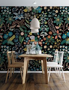 a dining room table with two chairs and a wallpaper