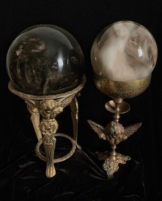 two antique brass and glass globes on stands