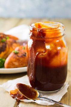 a glass jar filled with food sitting on top of a table next to a plate