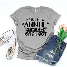 Elevate your style with our "Ain't No Auntie Like The One I Got" t-shirt! Perfect for showing love and appreciation for that special aunt in your life.  🧡 Premium Quality Fabric for Comfort  🌿 Eco-Friendly Print  🎨 Unique and Eye-catching Design  ✨ Available in Various Sizes  🎁 Ideal Gift for Auntie's Day or Birthdays  Show off your love in style with this thoughtful and trendy design! Product Features: Fabrication: Medium fabric (6.1 oz/yd² (206.8 g/m. Garment-dyed fabric. 100% ring-spun co Auntie Sayings For Shirts, Great Aunt Shirts Funny, Best Aunt Ever Shirt, Aunties Bestie Shirt, Auntie Meme, Showing Love, Gift For Aunt, Auntie Shirts, Xmas Tees