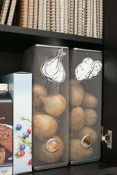 two metal containers filled with donuts on top of a shelf