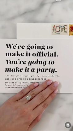 a woman's hand holding up a card that says, we're going to make it official you're going to make it a party