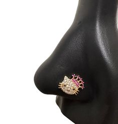 a black mannequin with a pink and white diamond ring on it's head