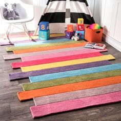 colorful rugs are laid out on the floor in a child's room