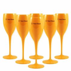 six yellow wine goblets are lined up on a white background with the words newport champagne written in black