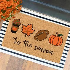 a door mat that says it's the season with fall decorations