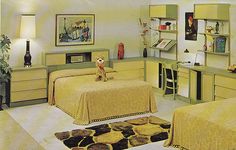 a bedroom with two beds and a desk in the middle is decorated in pale colors