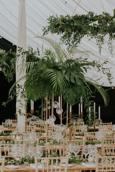 tables and chairs are set up with greenery