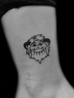 a black and white photo of a person's foot with a tattoo on it