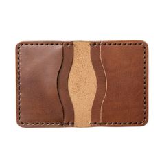 A Leather Wallet with unparalleled attention to detail.Upon holding this Natural colored wallet, you will immediately appreciate the craftsmanship. We take the time to hand-stitch every component of this wallet. We sand, burnish and polish the edges for an even, smooth feel. The soft, supple, leather feels lightweight yet durable at the same time. You won't be able to find this level of quality in a department store.Our full-grain leather means your wallet will develop character and patina. We h Handmade Classic Wallet, Hand-stitched Bifold Card Holder For Everyday Use, Cognac Leather Wallet With Smooth Grain, Classic Hand-stitched Wallets As Gifts, Artisan Brown Wallets With Interior Card Slots, Artisan Leather Rectangular Card Holder, Artisan Leather Card Holder With Card Slots, Artisan Brown Wallet With Interior Card Slots, Brown Wallets With Interior Card Slots For Everyday