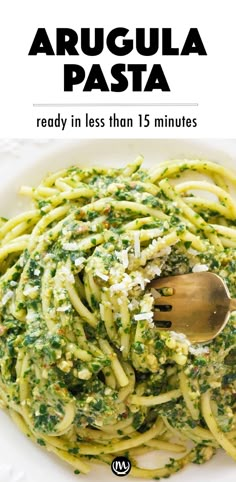 a white plate topped with pasta covered in pesto