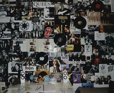 the wall is covered with records and pictures