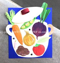 a paper plate with vegetables cut out on it