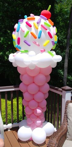 a large balloon sculpture made to look like an ice cream cone with sprinkles