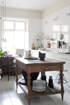 the kitchen is clean and ready to be used for cooking or baking, while also being used as a dining area