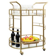 a gold bar cart with wine glasses and fruit in it, on a white background