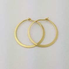 Gorgeous Solid 18k Hoops made from 16 gauge (1.3mm) wire.  The wire is hammered to nearly flat for a beautiful bold look.  Due to the handmade nature of these hammered earrings, there may be very slight surface inconsistencies rather than a fully flat 'machined' style surface.1" Size photographed; 2" size in 14k yellow gold shown in videoMETAL: Solid 18k Yellow GoldWIRE GAUGE/DIAMETER: 16 gauge (1.3mm) wire - Currently the thickest wire I offerEAR WIRE THICKNESS: Due to the thickness of the wire Handmade Sterling Silver Hoop Earrings In Yellow Gold, Small Hoop Yellow Gold Nickel-free Earrings, Handmade Yellow Gold Hoop Earrings In Sterling Silver, Handmade 14k Gold Hoop Earrings, Handmade Yellow Gold Sterling Silver Hoop Earrings, Hand Forged 14k Gold Hoop Jewelry, Gold Recycled Hoop Earrings, Hand Forged 14k Gold Round Earrings, Handmade 14k Gold Hoop Jewelry