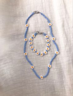 a blue and white beaded necklace with flowers