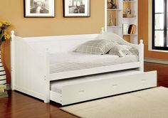 a white day bed with drawers underneath it