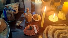 there are many candles and other items on the table