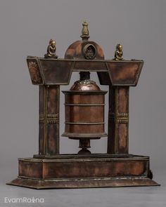 an old fashioned bell sitting on top of a stand