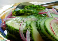 cucumber slices and onions are on a plate