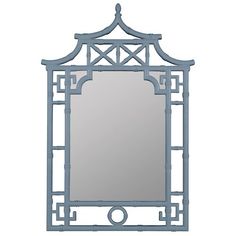 a mirror that is sitting on top of a table with a light blue frame around it