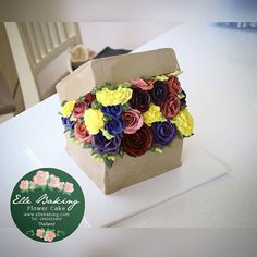 a paper bag with flowers on it sitting on a table