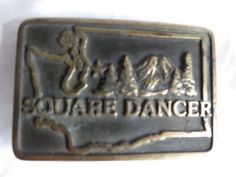 the square dancer belt buckle is on display