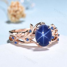 a ring with blue stones and leaves on it