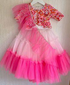 ✨ Dress your little princess in this stunning bubblegum lehenga for baby girl, designed to make her look adorable and stylish on any special occasion.  ✨ This beautiful outfit consists of a lehenga blouse and chunni, both adorned with intricate and beautiful patterns that add to its overall charm. The skirt and top of the outfit are fully lined, providing a comfortable and soft texture against your baby girl's delicate skin. The lehenga blouse is designed with an attractive neckline and a comfortable fit, perfect for your little one to wear all day long. ✨ The beautiful bubblegum color of the lehenga adds a touch of elegance and style to the overall outfit, while the intricate patterns and embroidery make it a true work of art. This beautiful outfit is perfect for any special occasion, inc Pink Ruffled Choli For Navratri, Festive Pink Lehenga With Ruffles, Pink Ruffled Lehenga For Diwali, Pink Ruffled Sharara For Festivals, Pink Anarkali Dress With Ruffles, Festive Pink Ruffled Anarkali Set, Festive Pink Ruffled Sharara, Fitted Multicolor Sharara With Ruffles, Pink Ruffled Choli For Wedding