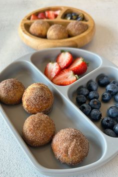 three trays filled with fruit and pastries next to each other on a table