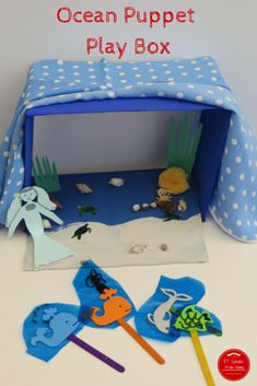 the ocean puppet play box is filled with toys