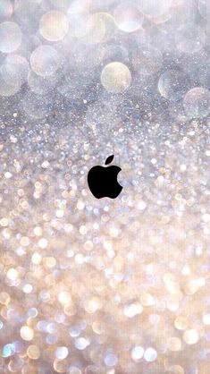 an apple logo is shown on the back of a glittery wallpaper with gold and silver circles