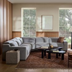 a living room with large sectional couch and coffee table