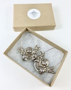 "These earrings are made from a vintage silver dish which had a beautiful embossed around the edge of flowers and other art nouveau motifs. I followed the line of the pattern into a point, drilled it and attached a sterling silver ear wire which is attached to either side of the charm. One side is hooked and unloops from the other side for you to insert the ear wire, and then clip it back up. They are very lightweight but are so eye catching. Measurements: Charm Length: 53 mm / 2.08\" Charm Widt Vintage Pierced Hoop Earrings For Wedding, Silver Pierced Hoop Earrings For Gift, Silver Pierced Hoop Earrings As Gift, Silver Hoop Earrings As Gift, Vintage Silver Flower Earrings With Ear Wire, Ornate Metal Hoop Earrings Gift, Silver Vintage Flower Earrings With Ear Wire, Ornate Silver Hoop Jewelry, Silver Handmade Hoop Earrings For Wedding