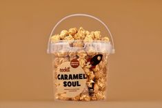 a plastic container filled with caramel popcorn