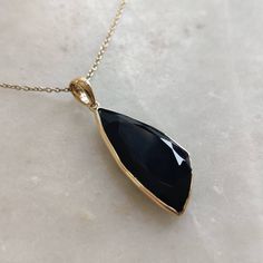 ITEM DESCRIPTION: >>The pendant is made from Solid 14K Yellow Gold. Gemstone used is absolutely natural and ethically sourced. >>Natural Black Onyx in bezel setting is studded on it with utmost precision. >>This is a minimalist design and is absolutely hassle-free and everyday jewelry. Gem: Black Onyx Gem size: 11x25 mm Gem weight: 6.40 carats Gold purity: 14K (58.33% approx.) Gold weight: 0.61 grams Gross weight: 1.89 grams The Gold purity is guaranteed and it comes with authe Black 14k Gold Pendant Jewelry, Black Gemstone Necklace In Fine Jewelry Style, Black Spinel Jewelry With Polished Finish, Yellow Gold Onyx Jewelry, Black Teardrop Gemstone Jewelry, Teardrop Onyx Gemstone Jewelry, Classic Black Faceted Jewelry, Black Faceted Teardrop Jewelry, Black Onyx Pendant