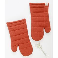 an orange oven mitt and pot holder