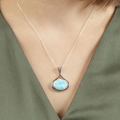 Divine Beauty of Larimar The divine beauty of the sky and the mysteries of the sea are perfectly captured in this stunning Mermaid Necklace - Larimar Crystal Pendant. Accented with a cushion-cut Larimar gemstone this necklace will surely make a lasting impression. Classic, timeless, yet so unique, just like you. Unique and Spiritual Stone The Larimar stone used in each piece has its own pattern and contains different hues, varying from light blue to blue-green, making each and every necklace tot Mystical Jewelry For Meditation, Mystical Oval Gemstone Necklace, Mystical Healing Necklace With Cabochon, Attract Good Energy, Luxury Larimar Necklaces For Gifts, Elegant Larimar Jewelry, Luxury Larimar Necklace Gift, Spiritual Round Larimar Jewelry, Larimar Crystal