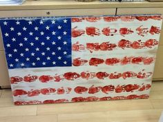 an american flag made out of handprints on a kitchen counter top with other items in the background