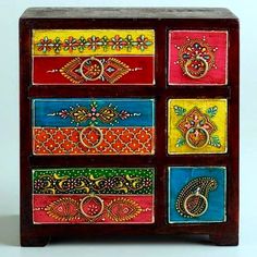 an ornate wooden drawer with colorful painted drawers on the front and sides, decorated with paisley designs