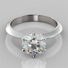 a white gold ring with a round cut diamond