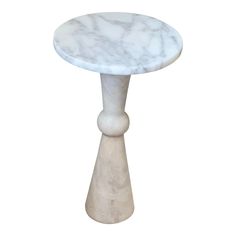 a white marble side table on a white background