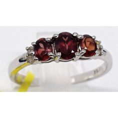 This Lovely Chuck Clemency Red Garnet Ring Was Found At An Estate Sale. It Is Made Of 925 Sterling Silver And Is Stamped "925" And "Sts" Inside The Band. The Ring Has Three Oval Shaped Dark Red Garnet Gemstones On The Front And Is Accented With Two Small Clear Quartz Gemstones Or Cz Stones. The Ring Measures Approximately .88" High X .79" Wide X .20" Deep. It Is A Dainty Petite Ring. It Measures 1.87 Grams. It Is A Ladies Size 7. It Is New With Tag Which Says, "Made In India". This Pretty Ring W Garnet Ring With Prong Setting, Classic Red Three Stone Rings, Classic Red Three-stone Ring, Formal Red Three Stone Rings, Elegant Silver Three-stone Gemstones, Elegant Three Stone Silver Gemstones, Garnet Ring With Diamond Accents, White Gold Ruby Three Stone Jewelry, Silver Three-stone Ruby Ring