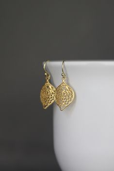 "Elegant matte gold vermeil wavy filigree charms dangle from gold vermeil balled earwires. Surprisingly light, you will hardly know you are wearing these. They go with absolutely everything! Gold filigree charms: 16x25mm Total length of earrings: almost 1 1/2\" All gold is 18k gold vermeil. These earrings are also available in silver... www.etsy.com/listing/610125110/bali-silver-earrings As the owner, maker, designer, and curator of this shop, I take great pride in providing you with jewelry tha Matte Gold Earrings, Flower Earrings Gold, Gold Filigree Earrings, Westlake Village, Bali Silver, 18k Gold Earrings, Gold Dangle Earrings, Filigree Earrings, Gold Filigree