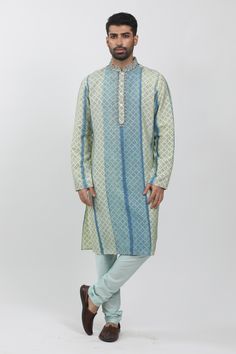 Light blue tie-dyed shaded kurta with zardozi embroidered mandarin collar, placket and all over geometric pattern block print. Paired with white gathered churidar.
Components: 2
Pattern: Printed and Hand Embroidered
Type Of Work: Block Print and Zardozi Work
Neckline: Mandarin Collar
Sleeve Type: Full Sleeves
Fabric: Tussar
Color: Blue
Other Details: 
Embroidered placket
Side slits on kurta
Kurta Closure: Front button placket
Note: The blue churidar worn by the model is not for sale
Occasion: Sa Festive Cotton Silk Block Print Kurta, Designer Wear Kurta With Block Print And Traditional Drape, Transitional Chanderi Kurta With Bandhani Print, Straight Cotton Silk Kurta With Bandhani Print, Multicolor Bandhani Print Kurta For Transitional Season, Festive Block Print Cotton Silk Kurta, Cotton Bandhgala Straight Kurta For Transitional Season, Designer Block Print Kurta With Traditional Drape, Cotton Silk Block Print Traditional Wear For Eid