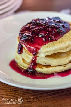 a stack of pancakes with blueberry syrup on top and the words homemade blackberry syrup